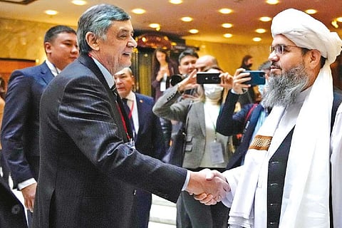 Russian envoy to Afghanistan Zamir Kabulov greeting a member of the Taliban delegation in Moscow
