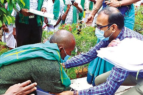 A farmer falls at the feet of Collector GS Sameeran seeking to drop move to acquire their lands
