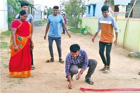 Family members and villagers celebrate Mariyappan Thangavelu winning silver medal with cackers