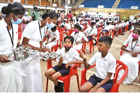 Health workers distributing deworming tablets among students at a school in Chennai on Monday.