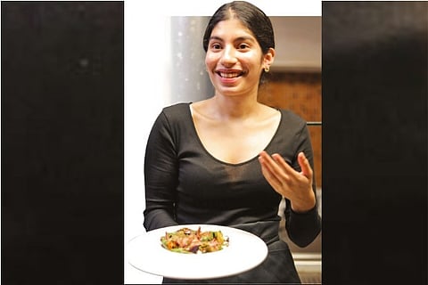 Chef Adhira with a dish that she prepared.