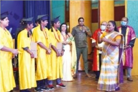 Chitra (in saree) conversing with hearing impaired students during a convocation ceremony