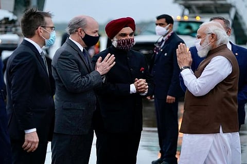 Officials welcoming Modi at the airport on Wednesday