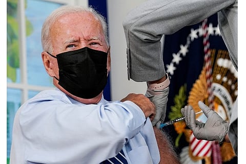 Joe Biden receiving a Covid-19 vaccine booster (Source: Reuters)