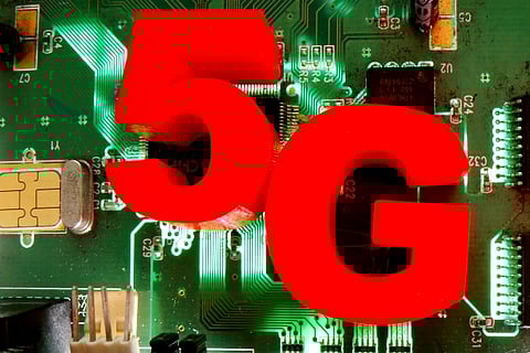 3d printed objects representing 5G are put on a motherboard (Credit: Reuters)