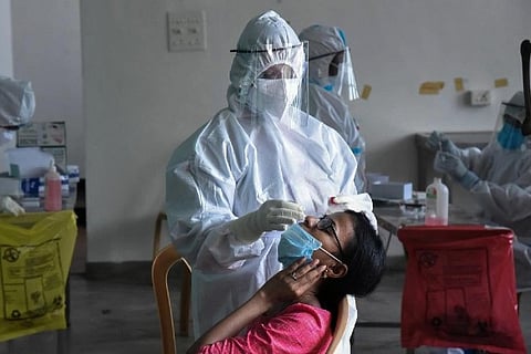 A health worker taking a swab sample (Image credit: PTI)