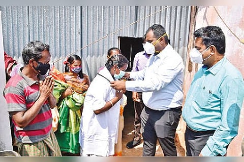 S Thangapechi being honoured by Madurai Collector S Aneesh Sekhar at Panamoopanpatti