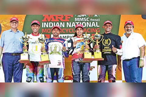 The title-winners with their trophies.