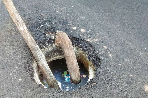 Bamboo sticks placed as a caution sign in a manhole not covered properly in Thoraipakkam