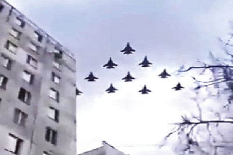 Fighter planes flying at a low altitude over a city