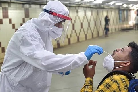 A health worker taking a swab sample (Image credit: PTI)