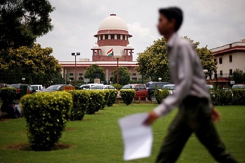 A man walks inside the premises of the Supreme Court (Credit: Reuters)