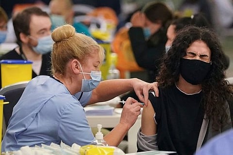 A health worker taking a swab sample from a person (Image credit: AP)