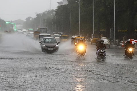 Vechiles passing over a flooded road during the rains (Photo credit: Manivasagan