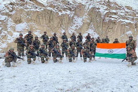 Indian Army troops holding a large tri-colour at the Galwan Valley (Credit: ANI)