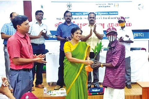 G Hemaprabha, director of ICAR-SBI, Coimbatore, hands over a sapling to a tribal resident in ATR