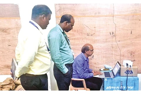 GSI officials checking one of the seismographs after installation at Pernambut taluk office
