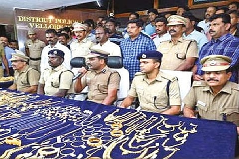 Gold jewellery laid out on a table