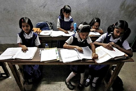 Schoolchildren study inside their classroom at a government-run school (Credit: Reuters)