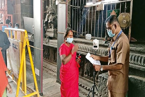 Officials check double vaccination certificates of devotees