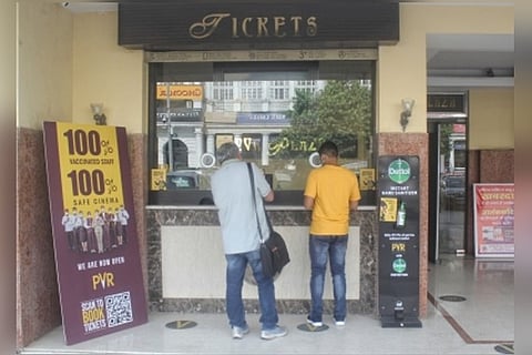 People in front of a ticket counter.