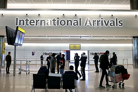 People wait and check the screens, as tighter rules for int passengers (Credit: Reuters)