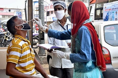 A health worker taking a swab sample (Image credit: PTI)