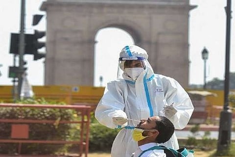 A health worker taking a swab sample (Image credit: PTI)