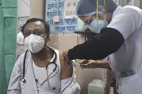 A health worker injecting a covid jab to a person (Image credit: PTI)