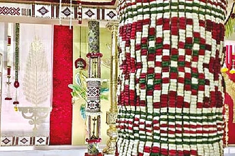 A stage decked with ?Maanikka Maalai? made of colorful flowers.