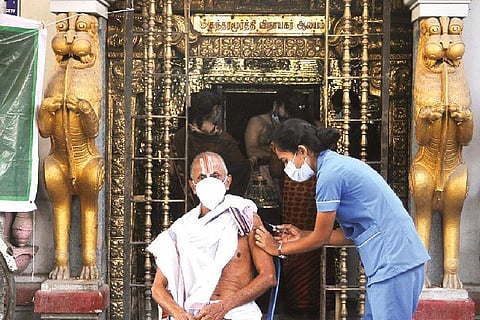 A temple priest receiving a booster shot at a special camp in Triplicane on Thursday