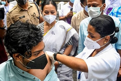 A health worker injecting a covid jab to a person (Image credit: PTI)