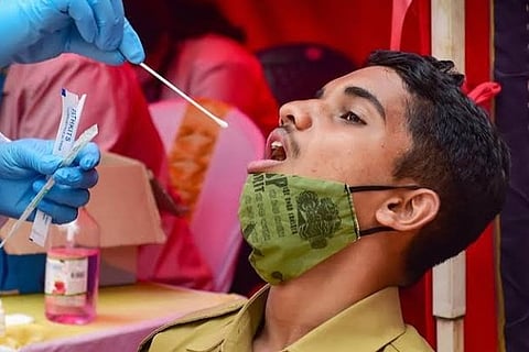 A health worker taking a swab sample (Image credit: PTI)