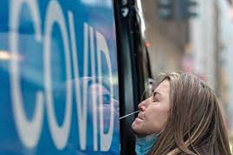 A woman takes a coronavirus test at a pop-up testing site (Credit: Reuters)