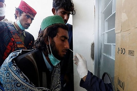 A health worker taking a swab sample (Image credit: PTI)