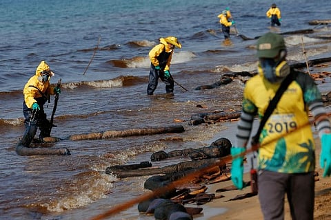 Workers cleaning the spill.