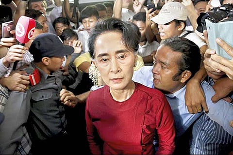 Opposition leader Aung San Suu Kyi arrives to vote