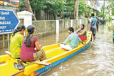 A boat man ferries residents from a locality near the Velachery lake