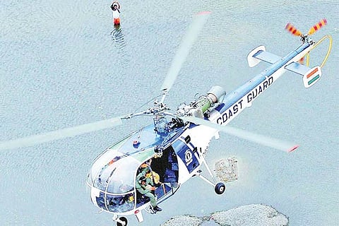 A chopper of the Coast Guard hovers over inundated areas of Chennai
