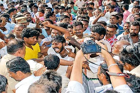 Public thwart the self-immolation attempt by a protester at Alanganallur on Tuesday