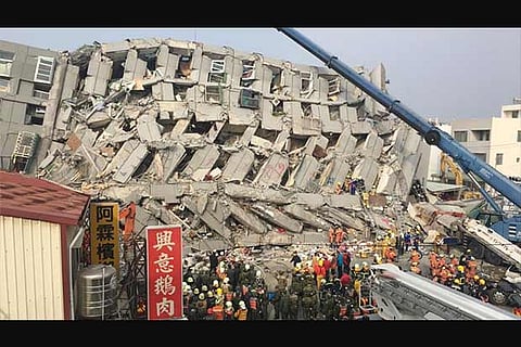 The 17-story Wei Guan building collapsed after a powerful quake stuck Tainan (Al Jazeera)