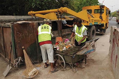 Environment protectors engaged in segregating garbage as part of the solid waste management project