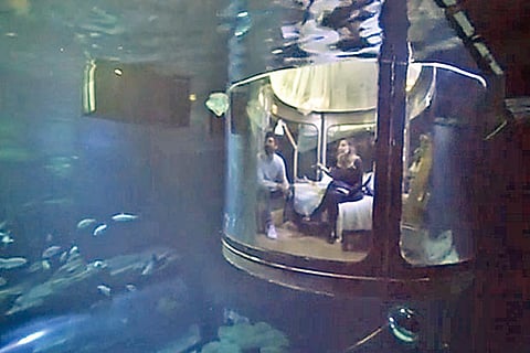 Image taken from a video grab of a couple in the ?bedroom? while sharks swim lazily around