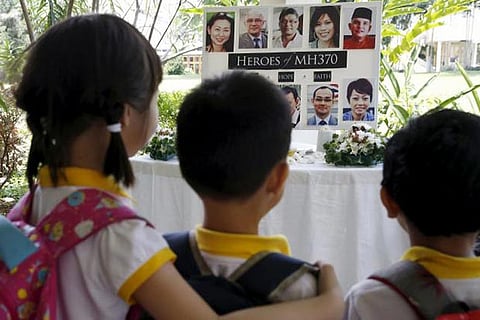 Children viewing photos of MH370 victims