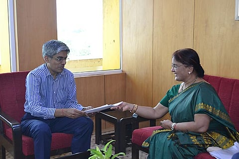 Prof. Bhaskar Ramamurthi receiving the policy documents from Muralidharan?s wife Girija