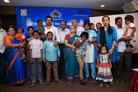 Actor Karthi with parents of children suffering from rare diseases at an event in the city