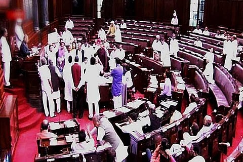 A screen grab of members protesting in the well of Rajya Sabha in New Delhi on Monday