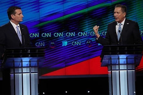 Republican US presidential candidates Ted Cruz (L) and John Kasich (R) at a debate last month