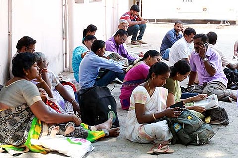 Parents waiting for their wards after seeing them off to the NEET centre on Sunday
