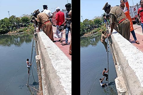 A fire service personnel brings out youth from the Cooum at Chintadripet (Photo: Kumar)